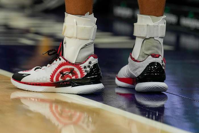 Stephen Curry's white, red, and black shoes.